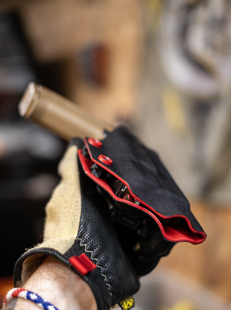 Fold-Over Outside the Waistband Kydex Holster wrapped in Black Cordura Fabric. Shown here for a Glock 19 with an Olight Baldr Mini. Showing the details of our handsanded edges.