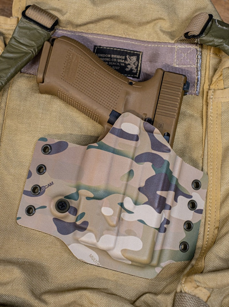 Multicam Original Infused Kydex on a Light Bearing OWB Holster for a Glock 19 with an Olight Baldr Mini