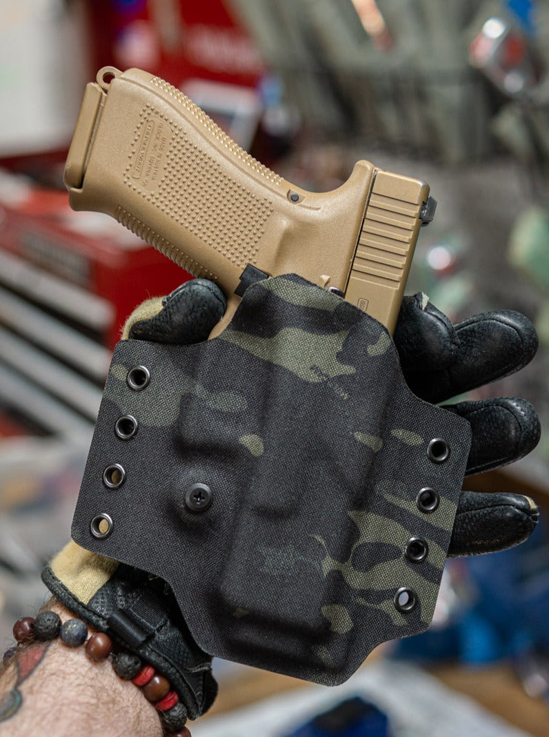 Outside the Waistband Non-Light Bearing Kydex Holster in Multicam Black fabric adhered to Kydex for a Glock 19.